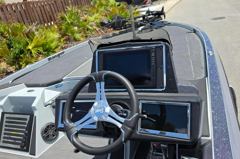 Slide: The Image of 2026 Ranger Z521R Cup-Equipped boat dashboard with advanced navigation displays and steering wheel. - 13