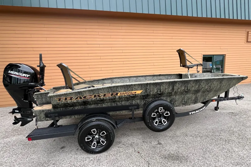 The Image of 2026 Tracker Grizzly 1756 T Marsh boat on trailer, featuring Mercury outboard motor. - 0
