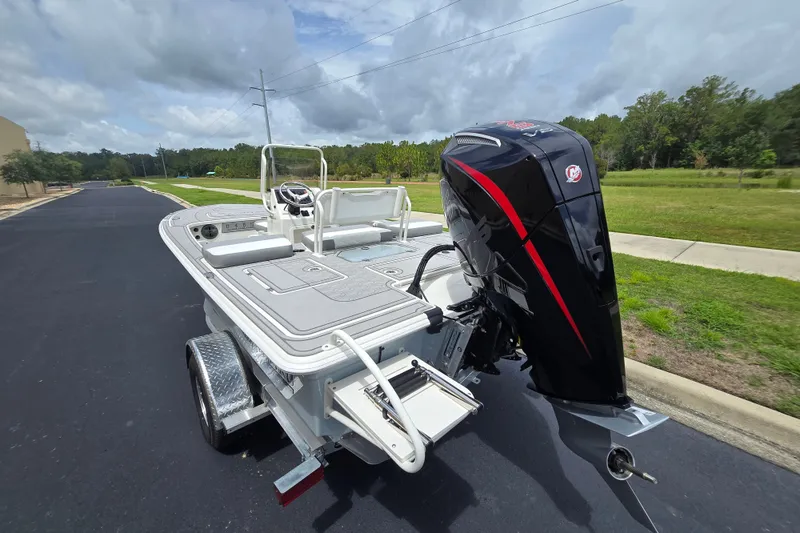 Slide: The Image of 2026 Mako 18 Pro Skiff boat with powerful outboard motor on a trailer. - 2