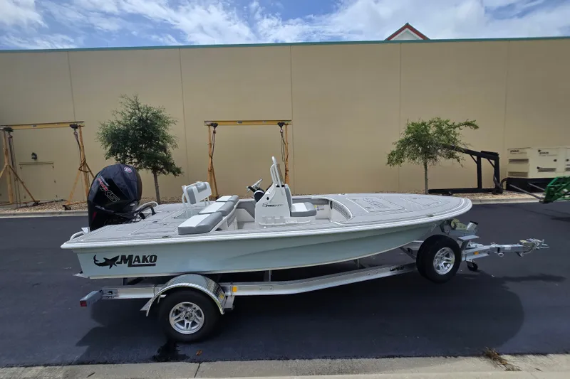 Slide: The Image of 2026 Mako 18 Pro Skiff boat on trailer, parked outdoors. - 1