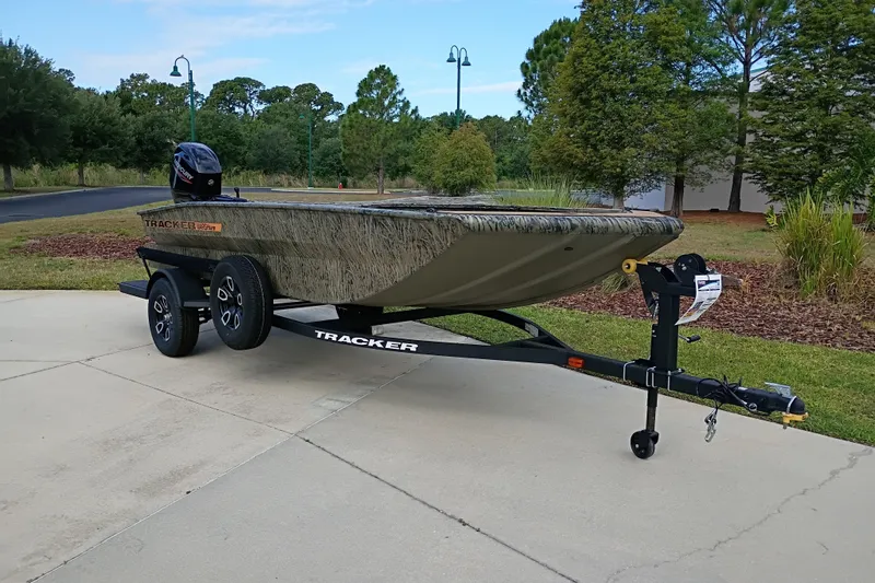 The Image of 2026 Tracker Grizzly 1756 T Marsh boat on trailer, parked outdoors. - 0
