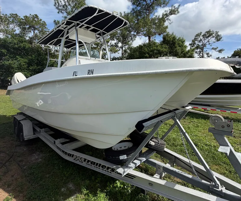 The Image of 2018 Twin Vee 260GF boat on trailer parked outdoors. - 0