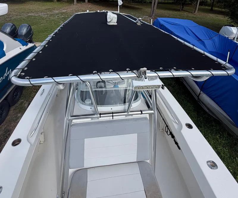 Slide: The Image of 2018 Twin Vee 260GF boat with black sunshade parked outdoors. - 11