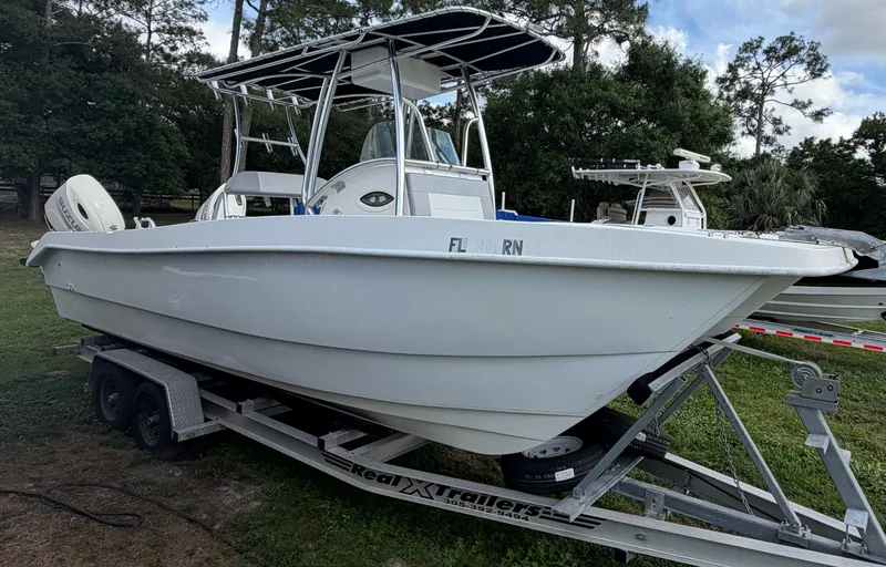Slide: The Image of 2018 Twin Vee 260GF boat on trailer outdoors. - 16