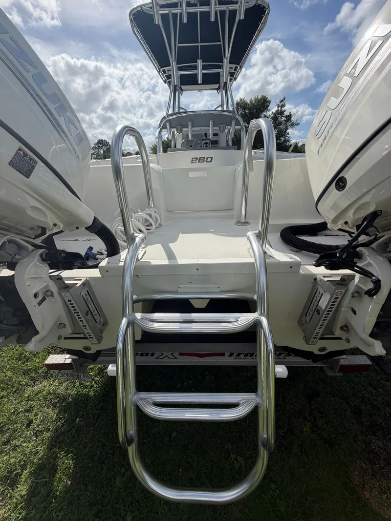 Slide: The Image of 2018 Twin Vee 260GF boat with ladder and engines. - 17