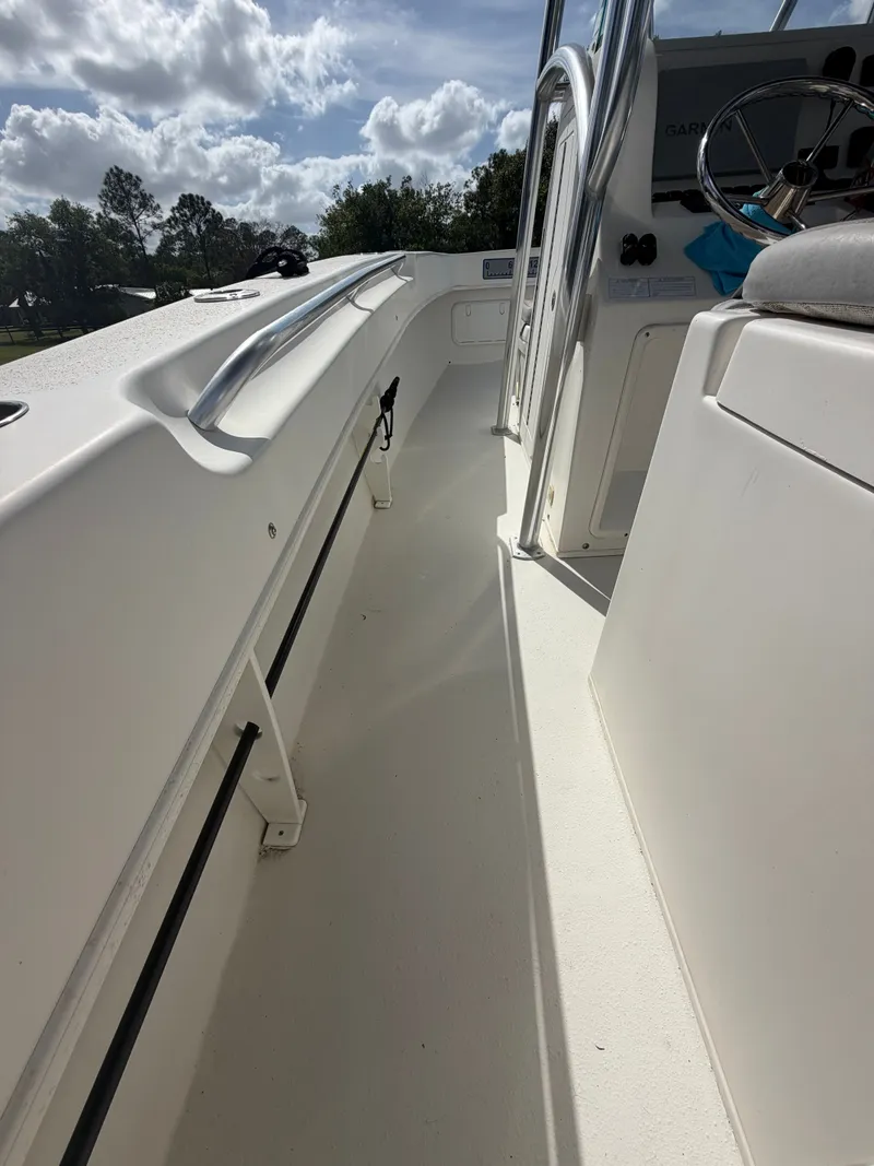 Slide: The Image of Interior view of a 2018 Twin Vee 260GF boat under sunny skies. - 7