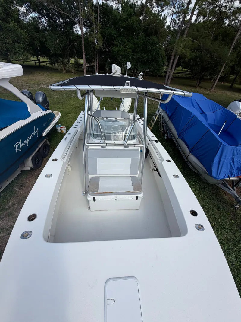 Slide: The Image of 2018 Twin Vee 260GF boat, white, parked on grass. - 8