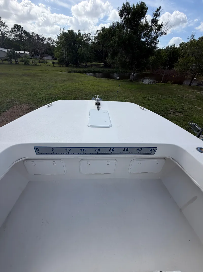 Slide: The Image of 2018 Twin Vee 260GF boat with measuring scale, parked outdoors. - 9