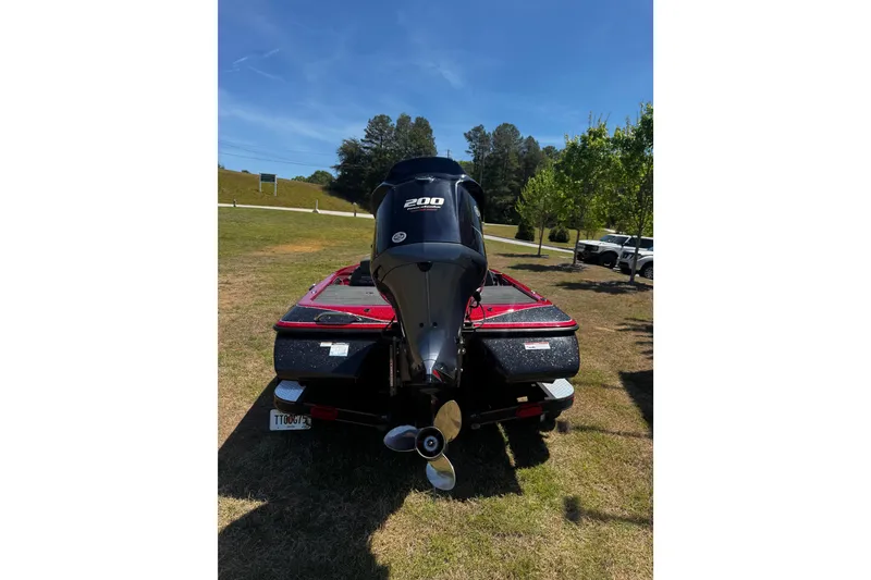 Slide: The Image of 2019 Skeeter ZX200 boat with powerful outboard motor, parked on grass. - 10