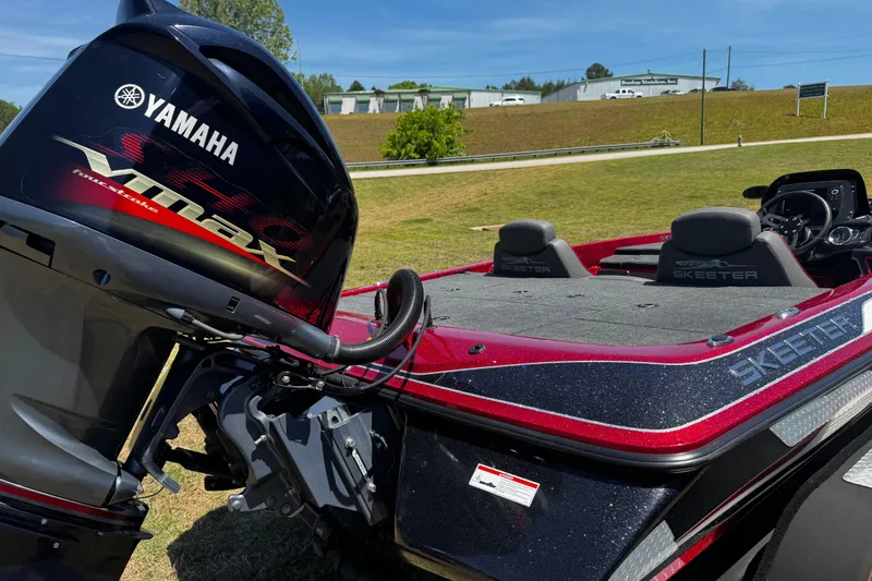 Slide: The Image of 2019 Skeeter ZX200 boat with Yamaha VMAX engine, parked on grass under clear blue sky. - 11