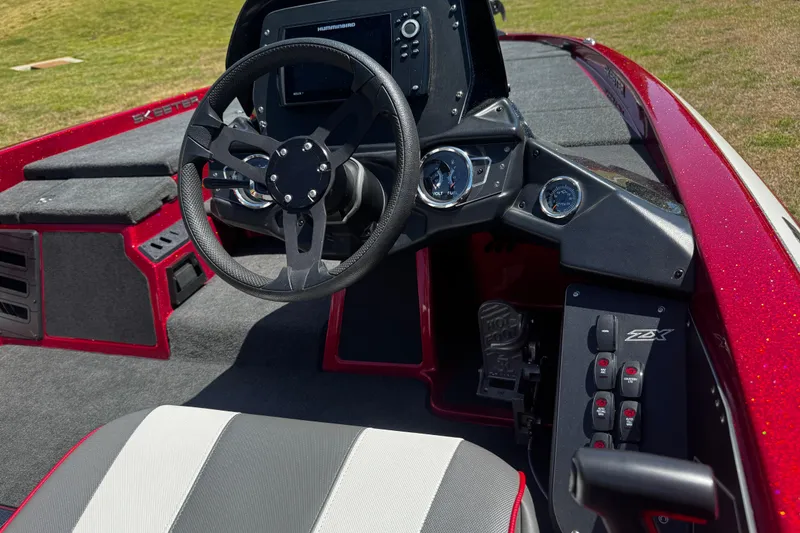 Slide: The Image of 2019 Skeeter ZX200 boat interior with steering wheel and control panel. - 14