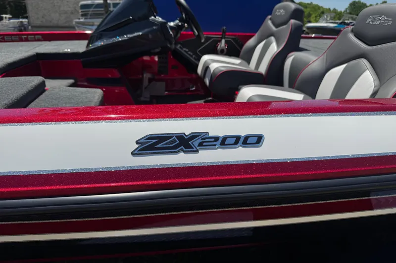 Slide: The Image of 2019 Skeeter ZX200 boat interior with logo, featuring sleek seating and steering console. - 2