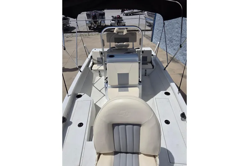 Slide: The Image of 2022 G3 Bay 18 GX boat interior with seating and console under canopy. - 11