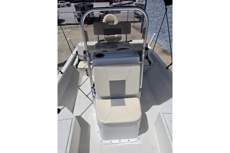 Slide: The Image of 2022 G3 Bay 18 GX boat interior with beige seating and steering console. - 12