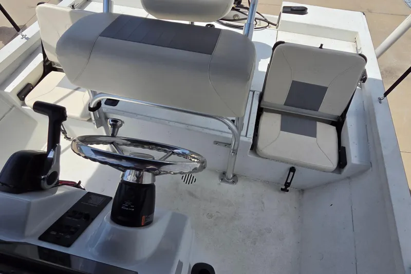 Slide: The Image of 2022 G3 Bay 18 GX boat interior with steering wheel and seating. - 13