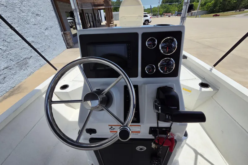 Slide: The Image of 2022 G3 Bay 18 GX boat dashboard with steering wheel and control panel. - 8