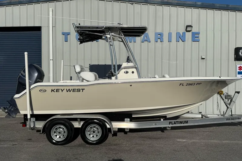 The Image of 2014 Key West 203 FS boat on trailer outside marine shop. - 0