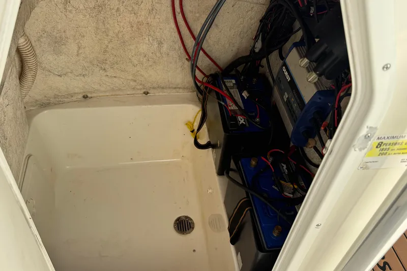 Slide: The Image of Battery compartment of a 2014 Key West 203 FS boat with wiring and components. - 13