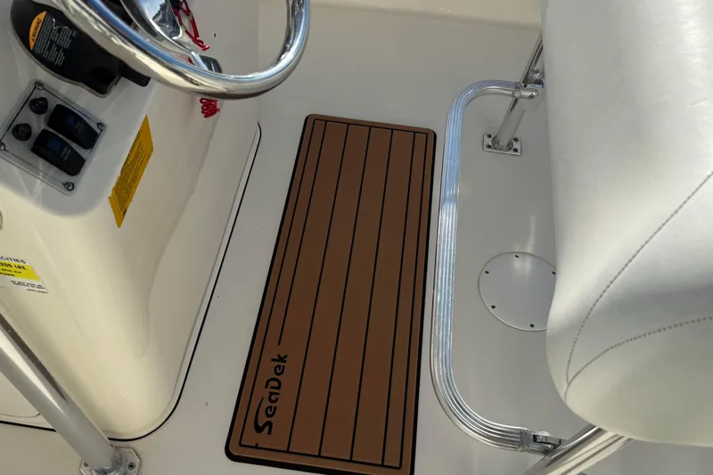 Slide: The Image of 2014 Key West 203 FS boat interior with SeaDek flooring and steering console. - 15