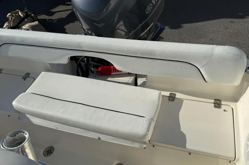 Slide: The Image of 2014 Key West 203 FS boat interior with white seating and visible fire extinguisher. - 16