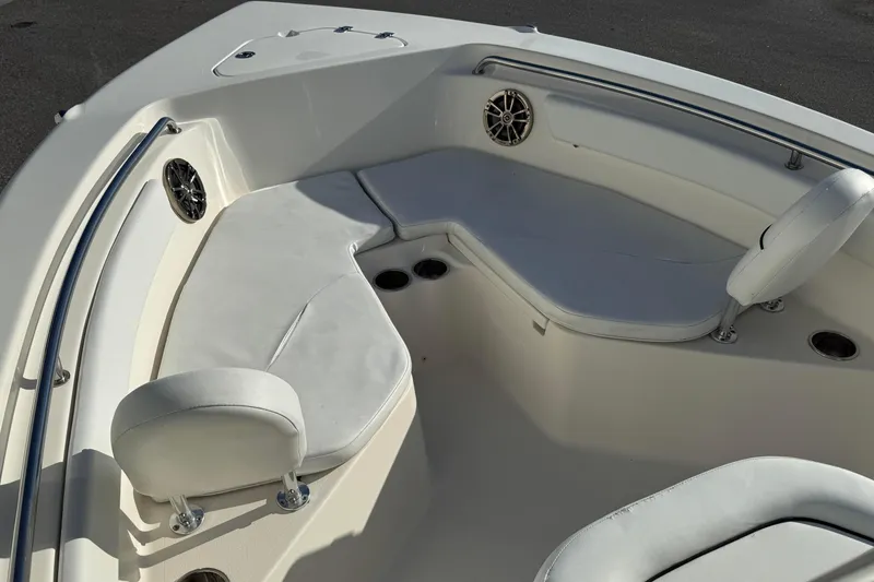Slide: The Image of 2014 Key West 203 FS boat interior with white seating and cup holders. - 7