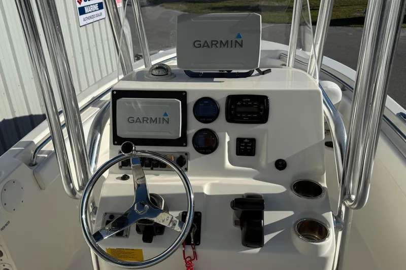 Slide: The Image of 2014 Key West 203 FS boat console with Garmin navigation system and steering wheel. - 8