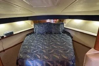 Slide: The Image of 2002 Pursuit 3800 Express cabin with cozy bed and ambient lighting. - 11