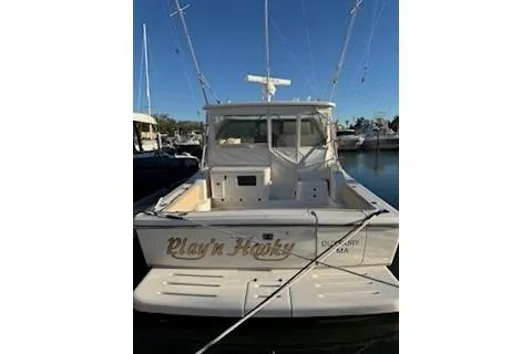 Slide: The Image of 2002 Pursuit 3800 Express boat docked at marina, rear view. - 14