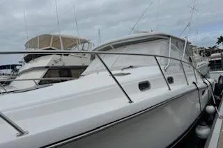 Slide: The Image of 2002 Pursuit 3800 Express yacht docked at marina under cloudy sky. - 2