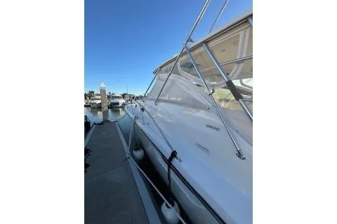 Slide: The Image of 2002 Pursuit 3800 Express yacht docked at marina under clear blue sky. - 3