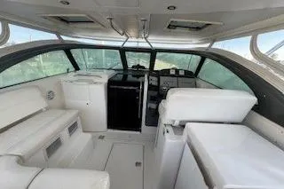 Slide: The Image of 2002 Pursuit 3800 Express boat interior with white seating and control panel. - 5