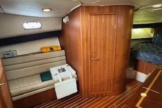 Slide: The Image of 2002 Pursuit 3800 Express cabin interior with wood paneling and seating area. - 9