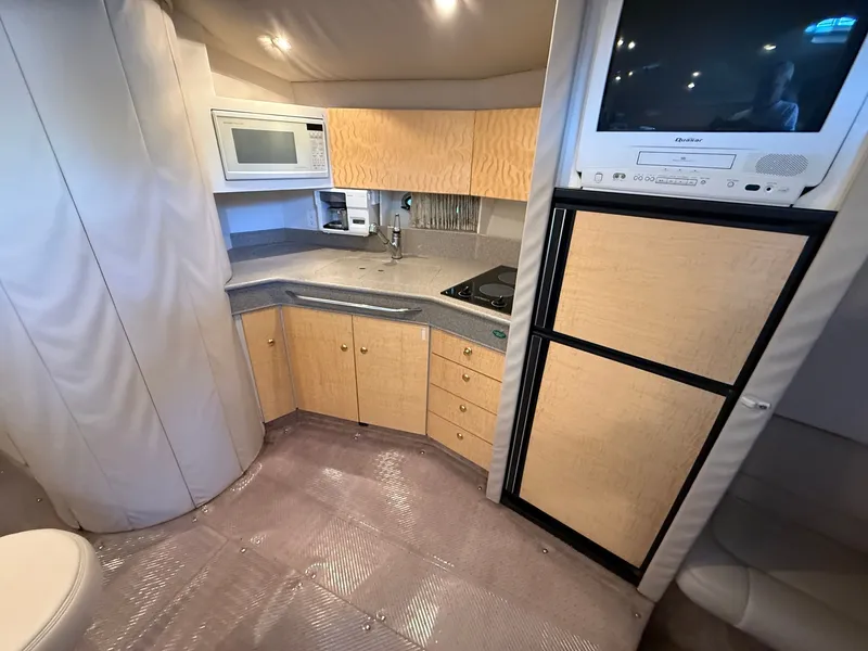 Slide: The Image of Interior of 1999 Formula 41 Performance Cruiser with kitchen and TV. - 15
