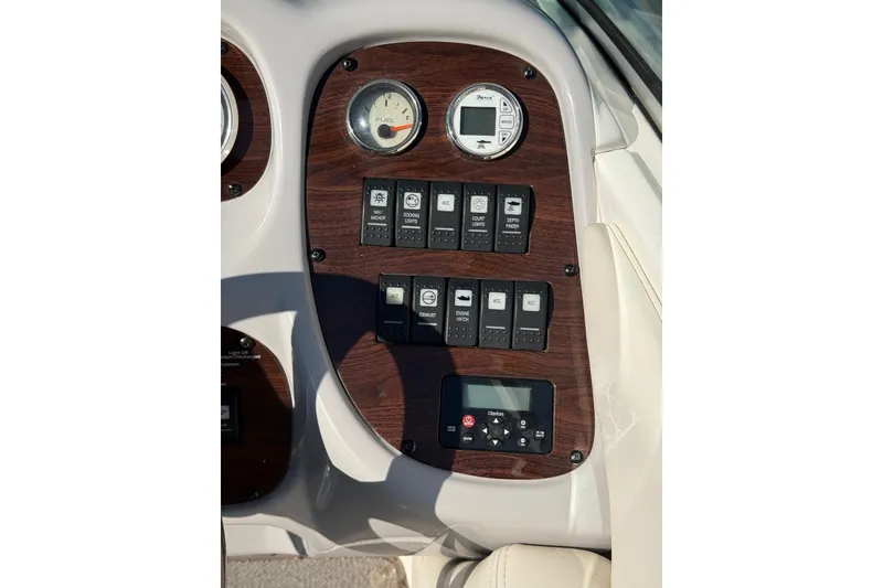 Slide: The Image of 2005 Chaparral 236 SSi dashboard with fuel gauge and control switches. - 11