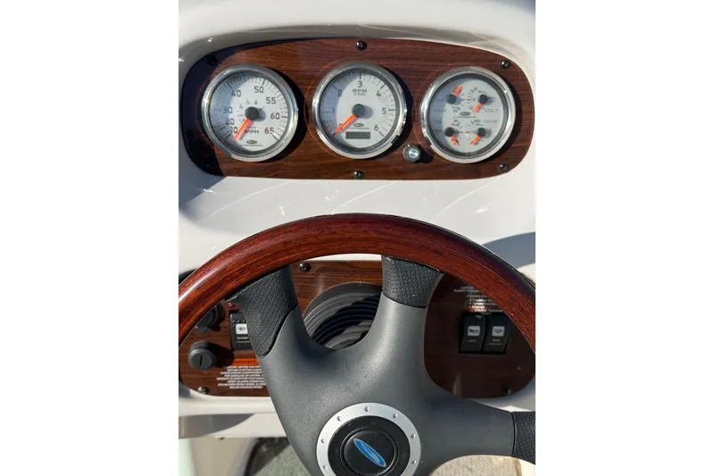 Slide: The Image of Dashboard of 2005 Chaparral 236 SSi boat with gauges and steering wheel. - 12