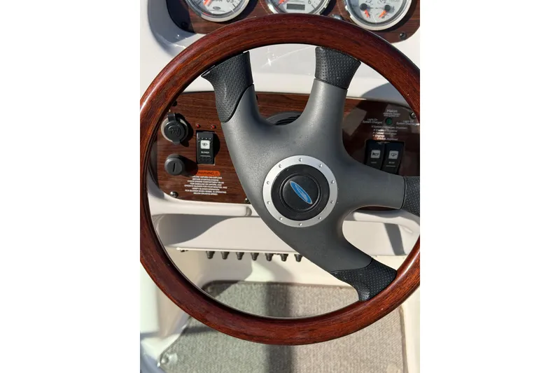 Slide: The Image of Steering wheel of a 2005 Chaparral 236 SSi boat with wood and leather accents. - 13
