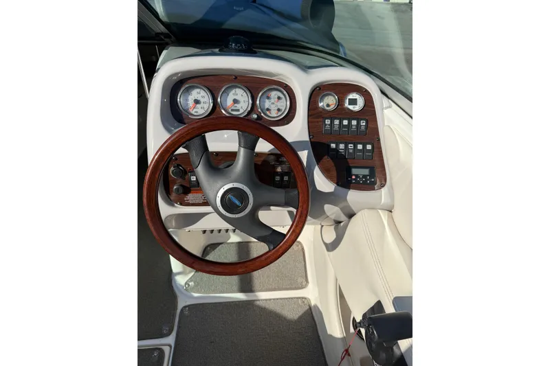 Slide: The Image of Dashboard of a 2005 Chaparral 236 SSi boat with wood accents and gauges. - 14