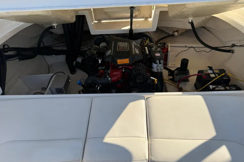 Slide: The Image of Engine compartment of a 2005 Chaparral 236 SSi boat, showcasing the motor and battery setup. - 15