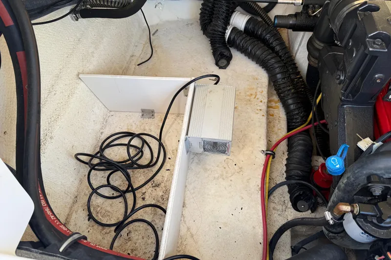 Slide: The Image of Engine compartment of a 2005 Chaparral 236 SSi boat with visible wiring and components. - 18
