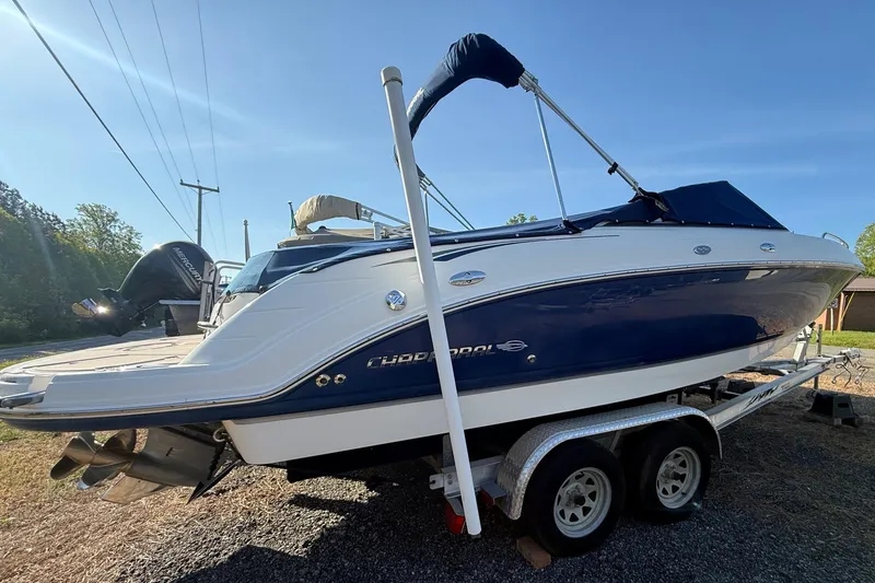 The Image of 2005 Chaparral 236 SSi boat on trailer, blue and white exterior, sunny day. - 2