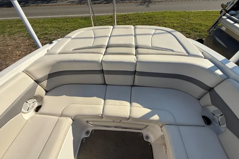 Slide: The Image of 2005 Chaparral 236 SSi boat interior with cushioned seating and speakers. - 22