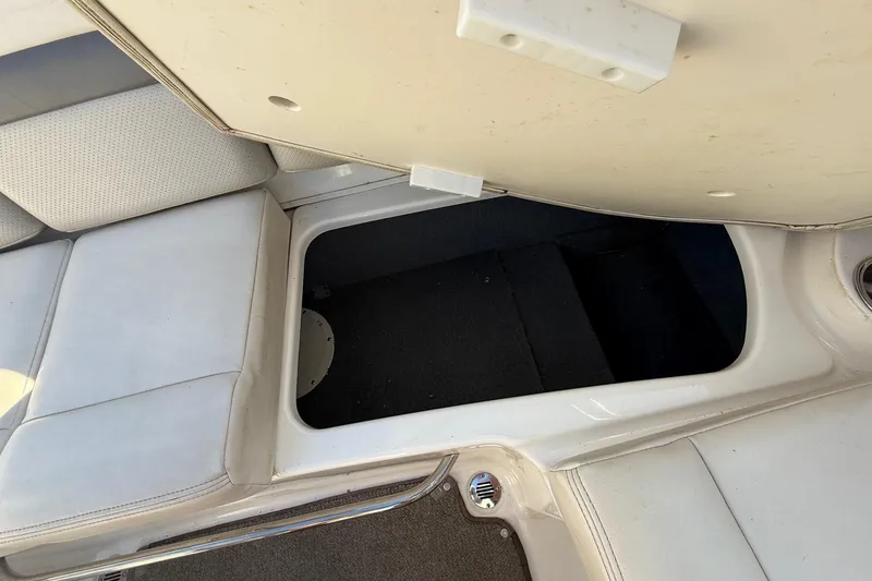 Slide: The Image of 2005 Chaparral 236 SSi boat interior storage compartment with cushioned seating. - 26