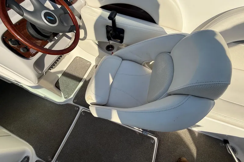 Slide: The Image of Interior of a 2005 Chaparral 236 SSi boat featuring a steering wheel and captain's seat. - 28