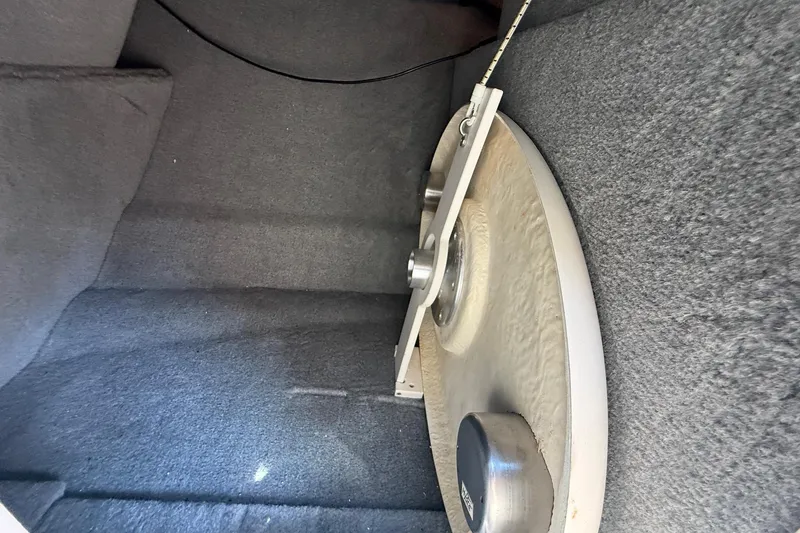 Slide: The Image of Interior view of a 2005 Chaparral 236 SSi boat, featuring carpeted storage space. - 33