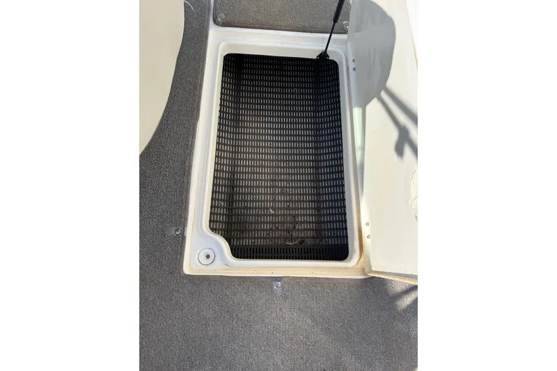 Slide: The Image of Open storage compartment on 2005 Chaparral 236 SSi boat with black mat inside. - 36
