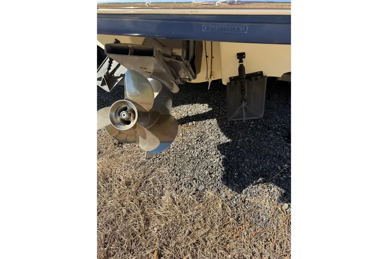 Slide: The Image of 2005 Chaparral 236 SSi boat propeller and stern detail on gravel surface. - 38