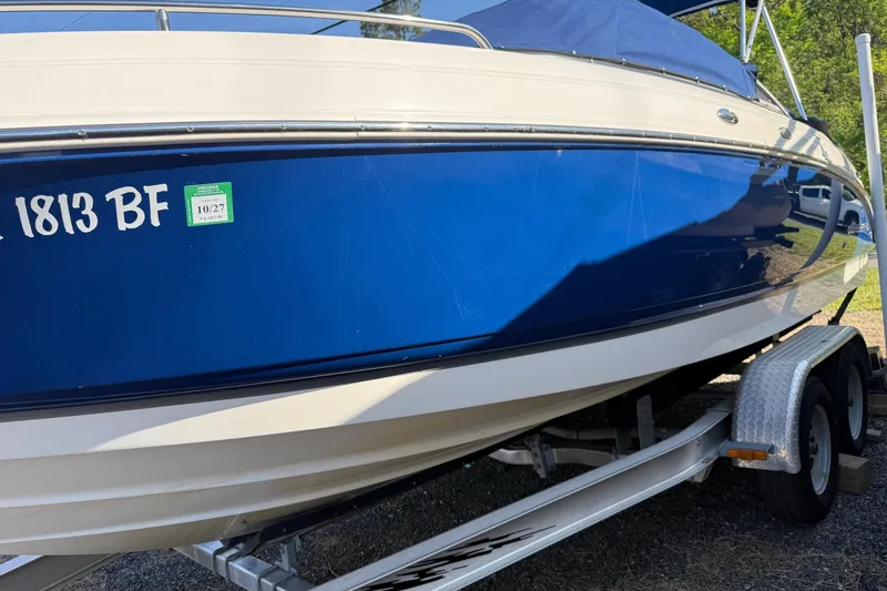 Slide: The Image of 2005 Chaparral 236 SSi boat on trailer, blue and white exterior, registration sticker visible. - 4