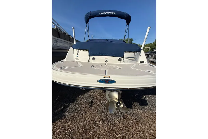 Slide: The Image of 2005 Chaparral 236 SSi boat with blue canopy and visible propeller. - 7