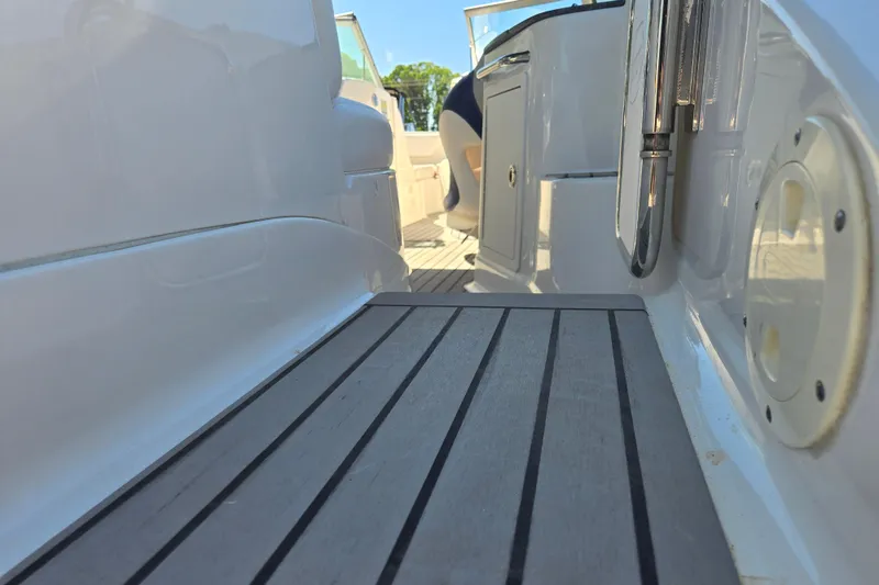 Slide: The Image of 2010 Chaparral Sunesta 224 boat interior with sleek white design and modern fittings. - 13