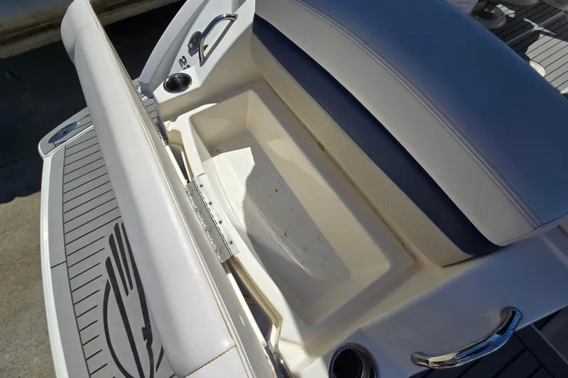 Slide: The Image of 2010 Chaparral Sunesta 224 boat seat with storage compartment and cup holder. - 19